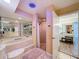 Luxurious main bathroom with shower, tub, and vanity at 44 Pinewood Cir, Safety Harbor, FL 34695