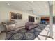 Inviting outdoor space with grill, sofa, tile flooring, and ceiling fan at 44 Pinewood Cir, Safety Harbor, FL 34695
