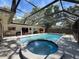 Enclosed pool featuring a jacuzzi and open access to the home's interior at 44 Pinewood Cir, Safety Harbor, FL 34695