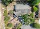 Bird's eye view of the home showcasing the roof, yard, driveway and surrounding trees and neighborhood at 506 Summerwood Ct, Tarpon Springs, FL 34689