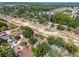 Aerial view of a neighborhood close to a lake, showcasing the nearby trees, homes and area at 506 Summerwood Ct, Tarpon Springs, FL 34689