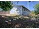 View of the home's backyard featuring an outdoor space, landscaping and a wooden fence line at 506 Summerwood Ct, Tarpon Springs, FL 34689