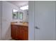 Bathroom featuring a wooden vanity with granite counters, a mirror and a modern light fixture at 506 Summerwood Ct, Tarpon Springs, FL 34689