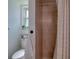 Tiled shower and toilet area in bathroom with shower curtain, window, and rack at 506 Summerwood Ct, Tarpon Springs, FL 34689