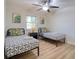 Bedroom with two beds, ceiling fan, and wood-look floors at 506 Summerwood Ct, Tarpon Springs, FL 34689