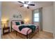 Comfortable bedroom with ceiling fan, window and wood-look floors at 506 Summerwood Ct, Tarpon Springs, FL 34689