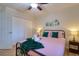This bedroom is decorated with monstera artwork and includes ample closet space at 506 Summerwood Ct, Tarpon Springs, FL 34689