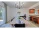 Bright dining area with modern lighting and a view of the kitchen, perfect for Gathering gatherings at 506 Summerwood Ct, Tarpon Springs, FL 34689