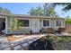 Inviting front yard with a charming walkway, tasteful landscaping, and an cozy outdoor seating area at 506 Summerwood Ct, Tarpon Springs, FL 34689