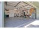 Spacious garage with overhead door, ample storage shelves, and utility connections, offering versatile space at 506 Summerwood Ct, Tarpon Springs, FL 34689