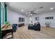 Spacious living room featuring new flooring, neutral paint, a ceiling fan, and a modern aesthetic at 506 Summerwood Ct, Tarpon Springs, FL 34689