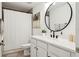Bright bathroom featuring a shower-tub combo with a white shower curtain and a modern vanity with a round mirror at 5351 Bridge St # 9, Tampa, FL 33611