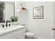 Modern bathroom featuring a vanity with black hardware, contemporary mirror, and a plant at 5351 Bridge St # 9, Tampa, FL 33611