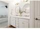 Bathroom featuring double sinks, quartz countertop, shiplap accent wall, and modern fixtures at 5351 Bridge St # 9, Tampa, FL 33611