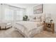 Inviting bedroom featuring a bed with decorative pillows and a side chair, illuminated by natural light from shuttered windows at 5351 Bridge St # 9, Tampa, FL 33611