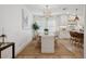 Elegant dining area with a chandelier, neutral tones, and an open view to the kitchen at 5351 Bridge St # 9, Tampa, FL 33611