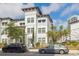 Beautiful three-story townhome with white facade, decorative tower, and manicured landscaping at 5351 Bridge St # 9, Tampa, FL 33611