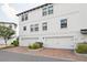 Townhome with brick paver drive, two-car garage and white exterior at 5351 Bridge St # 9, Tampa, FL 33611