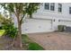 Attached two-car garage with a white door and paved driveway at 5351 Bridge St # 9, Tampa, FL 33611