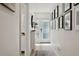 Bright hallway with modern decor and light wood floors leading to the front door at 5351 Bridge St # 9, Tampa, FL 33611