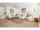 Spacious living room features a sectional sofa, glass coffee table, and hardwood floors at 5351 Bridge St # 9, Tampa, FL 33611