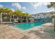 Community pool and lounge area with palm trees and cabanas at 5351 Bridge St # 9, Tampa, FL 33611