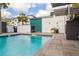 Community pool with a turquoise accent wall and wooden cabana at 5351 Bridge St # 9, Tampa, FL 33611