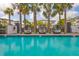Modern community pool with lounge seating and palm trees at 5351 Bridge St # 9, Tampa, FL 33611