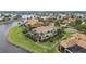 Aerial view of sprawling estate with meticulously maintained landscaping, private boat dock, and serene water views at 5405 Tybee Island Dr, Apollo Beach, FL 33572