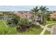 Aerial view of a luxurious home, landscaped gardens, and waterfront access at 5405 Tybee Island Dr, Apollo Beach, FL 33572