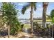 Scenic backyard view with lush landscaping, a dock, and tranquil waterfront scenery at 5405 Tybee Island Dr, Apollo Beach, FL 33572