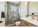 A stylish bathroom featuring a glass-enclosed shower with decorative tile and a modern vanity at 5405 Tybee Island Dr, Apollo Beach, FL 33572