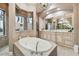 Luxurious bathroom with an oval tub, double vanity, and decorative chandelier at 5405 Tybee Island Dr, Apollo Beach, FL 33572