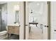 Bathroom leading into a game room with tile shower, view of the backyard, and natural lighting at 5405 Tybee Island Dr, Apollo Beach, FL 33572