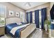Bedroom featuring a bed with dark blue bedding, wood floors, natural light, and sliding glass doors at 5405 Tybee Island Dr, Apollo Beach, FL 33572
