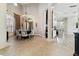 Elegant dining room with tile flooring, a modern chandelier, and views into the adjacent living areas at 5405 Tybee Island Dr, Apollo Beach, FL 33572