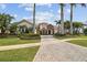 Beautiful front exterior with brick driveway, lush landscaping, and a grand entrance at 5405 Tybee Island Dr, Apollo Beach, FL 33572