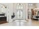 Elegant foyer with tile flooring, high ceilings, decorative lighting, and large glass double doors at 5405 Tybee Island Dr, Apollo Beach, FL 33572