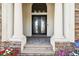 Grand front entrance with double doors, stone accents, and a well-manicured garden at 5405 Tybee Island Dr, Apollo Beach, FL 33572