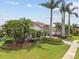 Beautiful home with lush landscaping, mature palm trees, and a well-manicured lawn at 5405 Tybee Island Dr, Apollo Beach, FL 33572