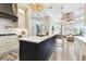 Bright kitchen with an island, modern appliances, marble countertops, and a beautiful view of the living room at 5405 Tybee Island Dr, Apollo Beach, FL 33572