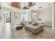Bright living room boasts a coffered ceiling, large sofa, and seamless access to the outdoors at 5405 Tybee Island Dr, Apollo Beach, FL 33572
