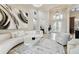 Bright and open living room featuring neutral decor, tile flooring, a decorative chandelier, and an arched entryway at 5405 Tybee Island Dr, Apollo Beach, FL 33572