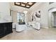 Spacious living room with tile floors, coffered ceiling, modern decor, and a view of the outdoor living area at 5405 Tybee Island Dr, Apollo Beach, FL 33572