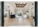 Bright and airy living room with tile flooring, coffered ceilings, modern furniture, and access to outdoor views at 5405 Tybee Island Dr, Apollo Beach, FL 33572