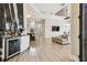 Open concept living area with hardwood floors, a bar, and a sofa at 5405 Tybee Island Dr, Apollo Beach, FL 33572
