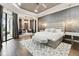 Spacious main bedroom with a gray accent wall, bench, and tray ceiling at 5405 Tybee Island Dr, Apollo Beach, FL 33572
