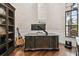 Elegant home office featuring a dark wood desk, guitar, and bright window at 5405 Tybee Island Dr, Apollo Beach, FL 33572