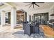 Elegant outdoor dining area featuring a built-in grill, modern ceiling fan, and spacious seating at 5405 Tybee Island Dr, Apollo Beach, FL 33572