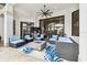 An attractive outdoor patio featuring wicker furniture, a fire pit, and a ceiling fan for comfortable entertaining at 5405 Tybee Island Dr, Apollo Beach, FL 33572